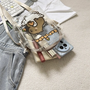 Detail of transparent PVC crossbody bag with cartoon capybara print and internal capacity