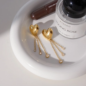 Golden stainless steel heart earrings with triple tassel chains and zircon accents
