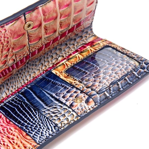 Detail of multi-color crocodile embossed leather wallet showing card slots and ID window