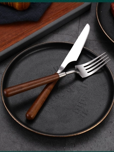 Close-up of 304 stainless steel knife and fork with premium walnut wood handles