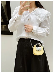 Close-up of a mini yellow jelly crossbody bag with silver chain strap and metal handle
