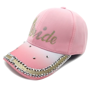Detail of pink baseball cap featuring Bride rhinestone lettering and studded brim edges