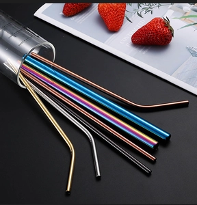 Detailed shot of multi-colored 304 stainless steel straws in a glass cup with strawberries