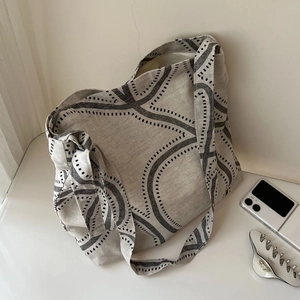Close-up of cotton linen canvas tote bag with abstract print and wide shoulder strap