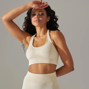 Detail of seamless ribbed knit fabric on cream yoga set with secure stitching