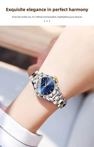 Detail of quartz watch with blue sunray dial and tri-tone stainless steel bracelet