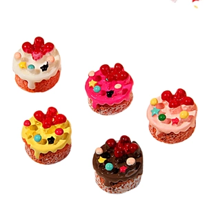 Vue à plat de gâteaux miniatures en résine colorée avec étoiles et crème à la fraise