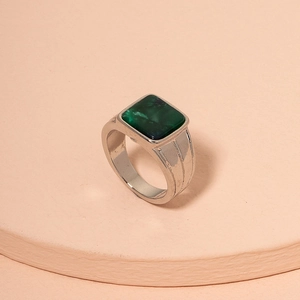 Minimalist turquoise ring in silver metal setting on a professional display stand
