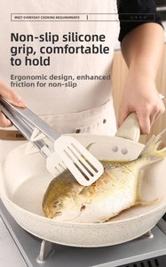 Detail of ergonomic stainless steel tongs with beige silicone non-slip head for frying