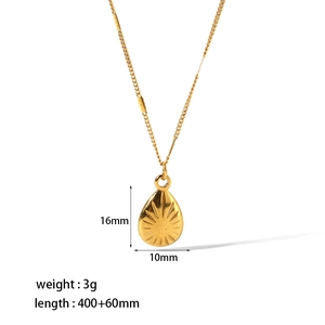 Detailed view of gold teardrop pendant with sunburst engraving and 400mm chain