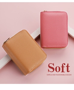 Detail of pink and brown leather card wallets with double zippers and soft texture