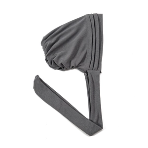 Detailed texture of dark grey soft velvet turban cap on a clean white background