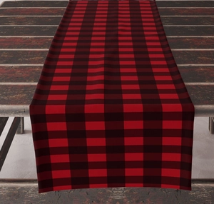 Close-up of red and black checkered linen table runner on a dark wood table surface