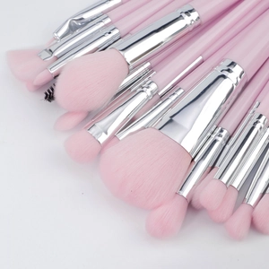 Close-up of soft pink bristles and silver ferrules of professional makeup brush set
