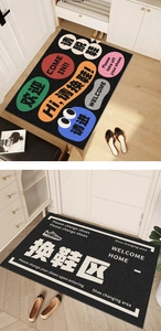 Detail of PVC door mat showing Please take off your shoes text in a home entrance