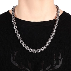 Close-up of men's chunky stainless steel keel chain necklace with retro scale texture