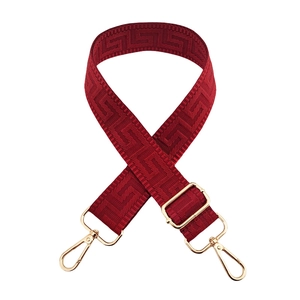 Dark red adjustable bag strap with gold hardware and geometric maze weaving pattern