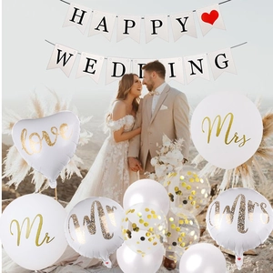 Close-up of Happy Wedding banner and gold confetti balloons in outdoor marriage setting