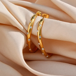Detail view of 18K gold plated hoop earrings featuring sparkling white zircon inlay