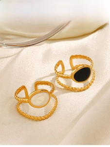 Detail of 18K gold plated double-layer rings with black and cream oval inlays on silk