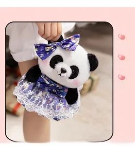 Detail of panda plush toy wearing a purple star-patterned lace dress and bow accessory