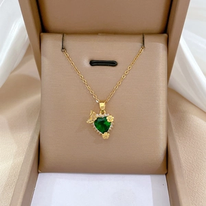 Luxurious gold titanium necklace featuring a green heart pendant with butterfly and flower