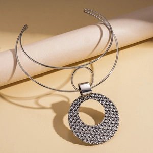 Detail of silver double-layered choker featuring a geometric textured round pendant