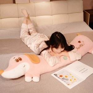 Pink plush dachshund long pillow toy with Happy embroidery in a cozy home setting