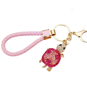 Turtle keychain with pink rhinestones, braided leather rope and golden metal ring