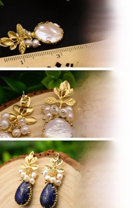 Macro detail of Baroque pearl earrings with 18K gold-plated leaves and lapis lazuli stone