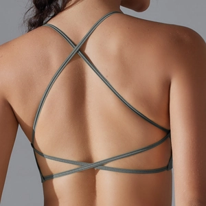 Detail of cross-back straps on seamless high-stretch sports bra in dark charcoal grey