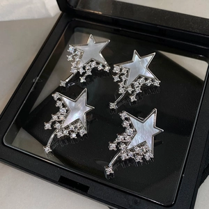 Elegant silver star earrings with mother-of-pearl and cubic zirconia in a jewelry box