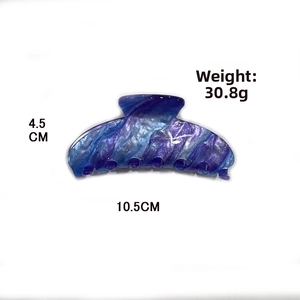 Detail view of large marble texture hair claw clip measuring 10.5cm and weighing 30.8g