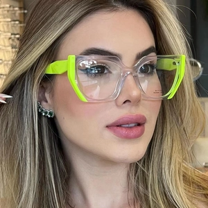 Close-up of stylish neon green and transparent acetate cat-eye glasses frame on a model