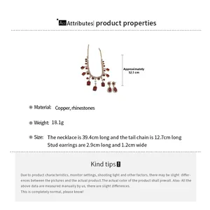 Detail view of gold fringe necklace and earrings set with red rhinestones and measurements