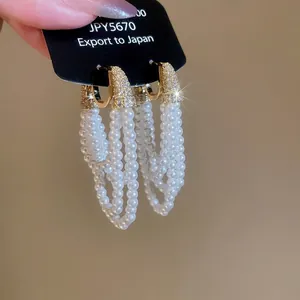 Boucles d'oreilles pendantes élégantes à perles multicouches et zircons en finition dorée