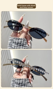 Detail of gold oval sunglasses with heart-shaped crystal rhinestones on the frame