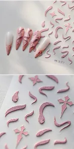 Macro view of pink 3D embossed nail stickers with snake and gothic cross patterns