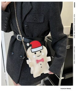 Detail of creative gingerbread man crossbody bag with gold chain on a wool blazer