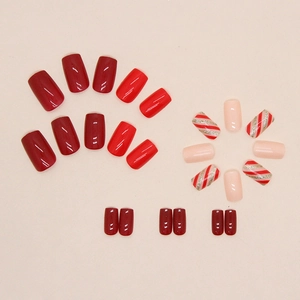 Glossy red and pink square press-on nails with festive Christmas striped glitter designs
