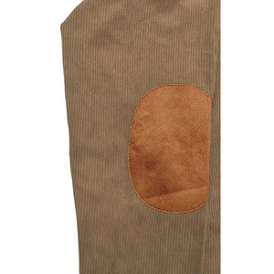 Detailed macro of brown corduroy fabric featuring durable oval elbow reinforcement patches