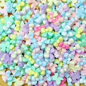Close-up of macaron color resin bow nail art charms and jewelry accessories