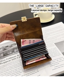 Close-up of brown vintage leather accordion card holder with gold clasp and large capacity