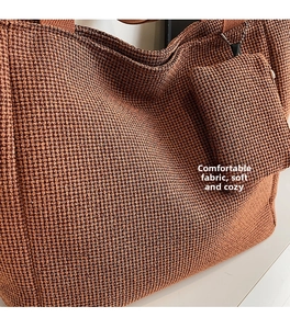 Detail of waffle knit fabric texture on terracotta tote bag with matching mini pouch
