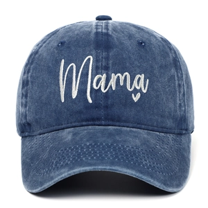 Close-up of white Mama embroidery and heart on navy washed denim baseball cap
