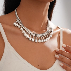 Detailed macro view of luxurious silver tassel necklace featuring large rectangular crystals