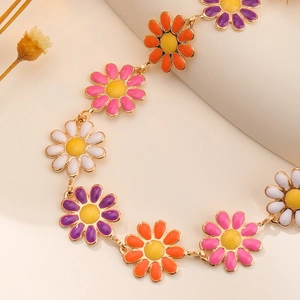 Elegant gold daisy bracelet featuring colorful enamel petals and a minimalist floral design