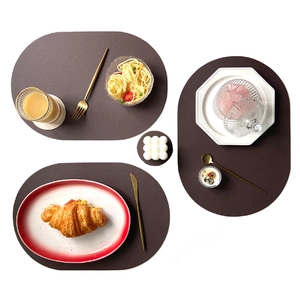 Oval and round dark brown PU leather placemats with heat insulation for dining tables