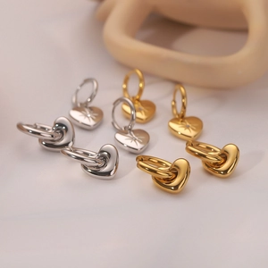 Minimalist 14k gold and silver heart earrings set with engraved star pattern and zircons