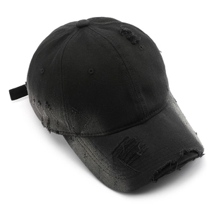 Stone-washed black cotton baseball cap with distressed rip details and adjustable strap